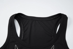 Close-up of black ribbed knit top with detailed neckline and metal bead decorations