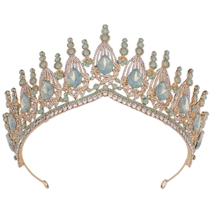 Detailed macro of gold bridal crown with light blue crystals and drop-shaped emerald gems