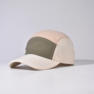 Detail view of a five-panel camper hat with metal eyelets and multi-color patchwork panels