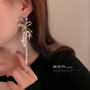 Sparkling silver bow heart tassel earrings with rhinestones for a luxury look