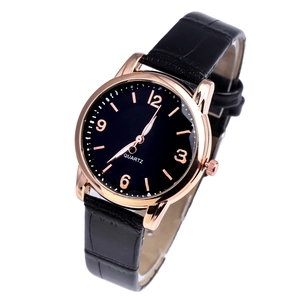 Detailed angled view of a quartz watch with black leather strap and rose gold case