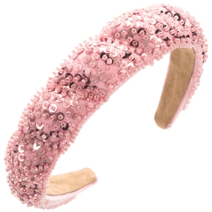 Macro detail of handmade pink sequin headband with textured beadwork and soft velvet lining