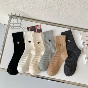 Detailed collection of vertical stripe cotton socks with tiny bee embroidery accents