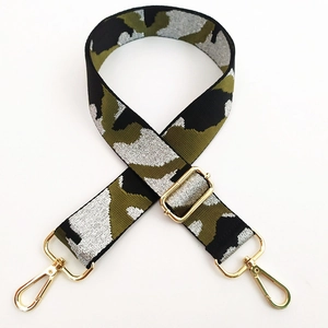 Detail of silver camouflage woven strap with golden lobster clasps and metal buckle