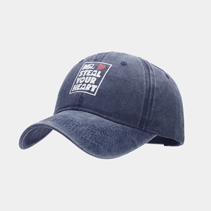 Close-up of MR. STEAL YOUR HEART print on a navy blue washed cotton baseball cap