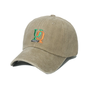 Detailed embroidery of UQ 1983 letters on washed khaki canvas baseball cap