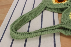 Close-up of handmade crochet sunflower tote bag showing green yarn weave details