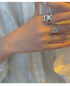 Detail shot of 925 sterling silver rings and bracelet with diamonds on hand