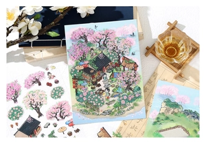 Gros plan d'autocollants 2.5D style chinois avec fleurs de cerisier et détails de livre rétro