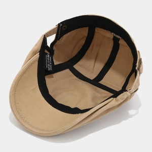 Detailed interior of cotton newsboy cap showing washing label and inner stitching