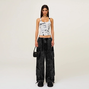 Tie-dye halter crop top with dark grey cargo pants and minimalist black star bag