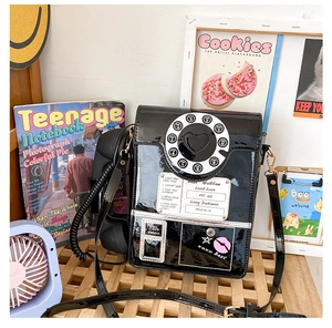 Detail of creative vintage black telephone bag with rotary dial and heart icon decoration