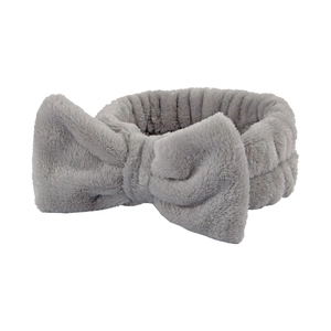 Bandeau de spa en peluche grise avec un grand nœud pour le lavage du visage et maquillage