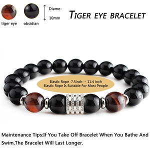 Detail of 10mm tiger eye and obsidian beaded bracelet showing natural stone textures