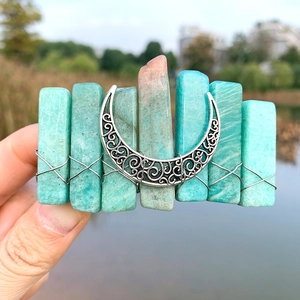 Bohemian crystal hair clip with natural stones and silver moon charm held over water