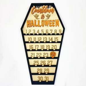Wooden coffin-shaped Halloween countdown calendar with pumpkin marker on white background