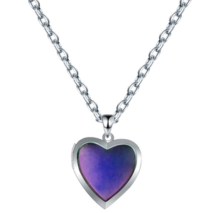 Detail of heart locket pendant with color-changing purple gradient inlay on silver chain