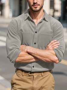Detail of grey corduroy shirt featuring chest pockets and premium vertical texture