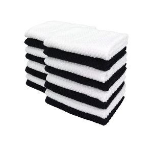 Close-up of stacked black and white checkered cotton waffle dishcloths and tea towels