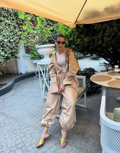 Street style view of a khaki two-piece set with oversized shirt and lantern pants