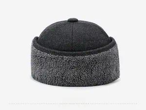 Rear view detail of a thermal winter trapper hat featuring gray wool and faux fur textures