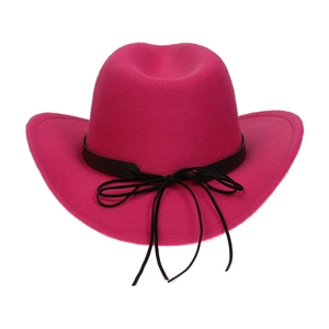 Detail of rose red felt cowboy hat with black leather band and bow on white background