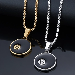 Detail of gold and silver number 8 billiard pendants with metal chains and reflections
