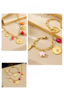 Close-up of gold-plated stainless steel jewelry set with colorful heart and flower charms