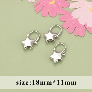 Three silver star lobster clasps in 18mm x 11mm size on a light green background