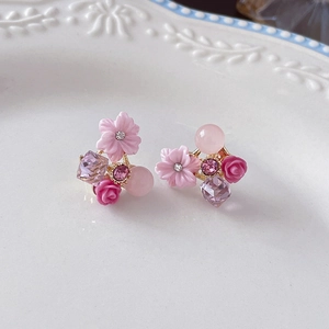 Detail showing pink flower earrings with cat-eye stone, rose bud and crystal pendant