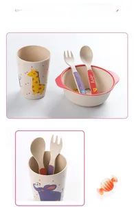 Close-up of bamboo fiber kids tableware with giraffe and elephant cartoon patterns