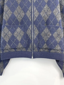 Detailed view of diamond quilted knit bomber jacket with zipper and ribbed hem