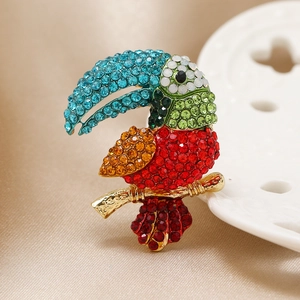 Vintage parrot brooch with colorful rhinestones on golden metal branch for women