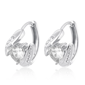 Macro view of silver heart-shaped zircon earrings with streamlined metal and bead details
