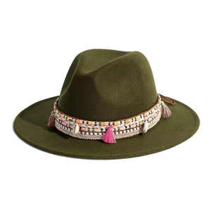 Close-up of olive green felt hat with bohemian woven band featuring shells and pink tassels