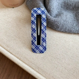 Detailed close-up of blue and white plaid fabric BB hair clip with woven texture detail