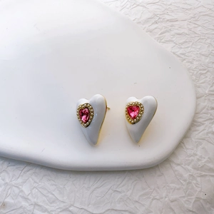 Elegant gold plated heart earrings with pink crystal and white enamel inlay details