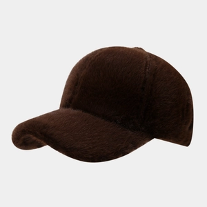 Detailed view of deep brown plush baseball cap with fuzzy texture and curved brim