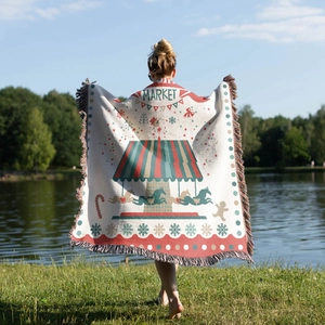 Detail of bohemian Christmas tree knitted blanket with fringe edge in outdoor lakeside setting