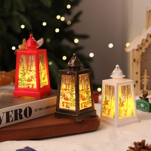 Close-up of three LED Christmas lanterns in red, bronze and white with Santa Claus motifs