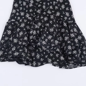 Black and white floral dress hem featuring layered ruffle details in lightweight chiffon