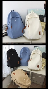 Detail showing minimalist embroidered letter and leather brand patch on canvas backpack