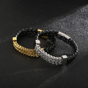 Detail of woven leather bracelets with gold and silver chain links and magnetic clasp