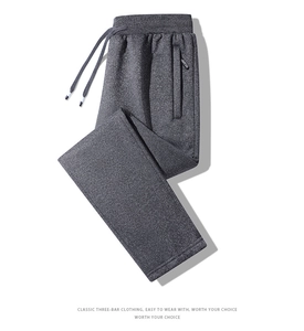 Close-up of dark grey joggers featuring elastic waistband with adjustable drawstrings