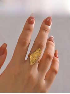 Macro detail of adjustable golden ginkgo leaf ring showing delicate radial vein texture