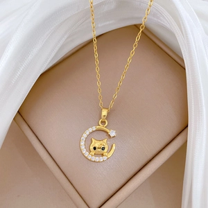 Titanium steel moon and cat necklace with sparkling zircons on a soft cream display