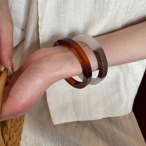 Detail of resin and wood patchwork bracelet showing natural wood grain and amber resin texture