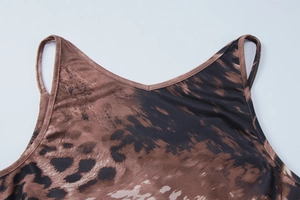 Close-up of the delicate V-neckline and leopard print pattern on a brown camisole dress