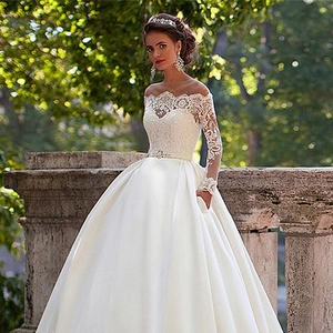 Elegant off-the-shoulder lace wedding dress with long sleeves and large ball gown skirt