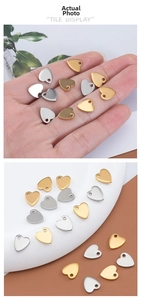 Close-up of heart-shaped stainless steel charms for DIY bracelets in gold and silver